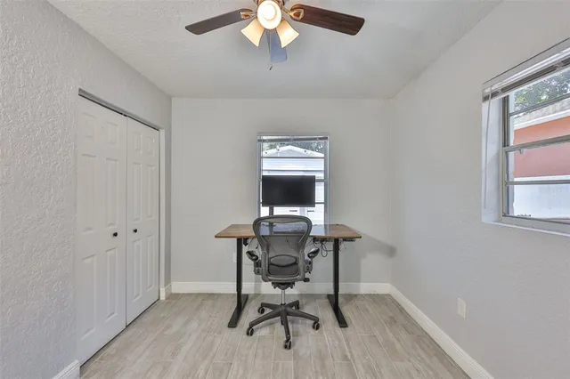 a view of a livingroom with furniture and chandelier fan