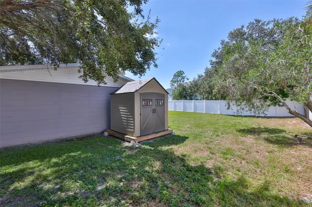 a view of a house with a backyard and a garage
