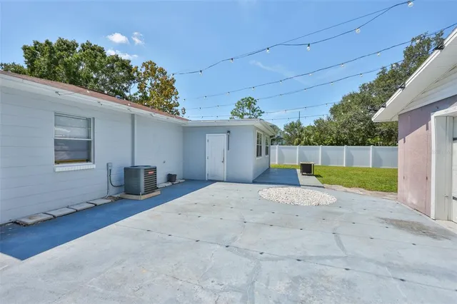 an aerial view of residential houses with outdoor space and parking