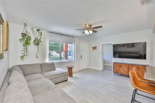 a living room with furniture and a wooden floor