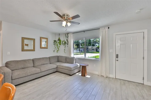 a living room with furniture and a chandelier