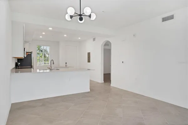 a view of an empty room with a kitchen
