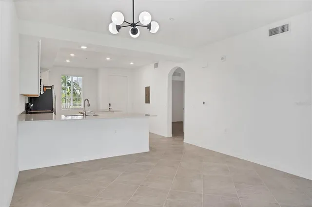 a view of an empty room with a kitchen