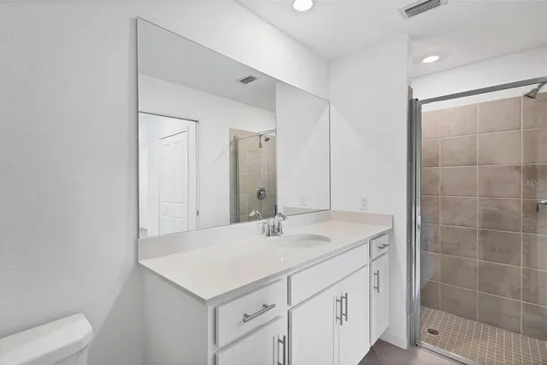 a bathroom with a sink vanity and a mirror