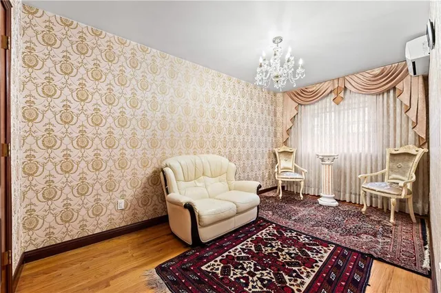 a living room with furniture and a chandelier