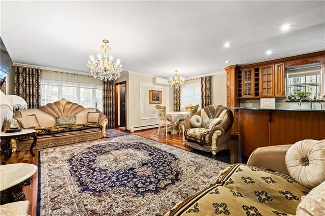 a living room with furniture and a chandelier