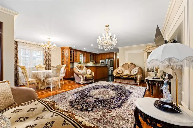 a living room with furniture a chandelier and a fireplace
