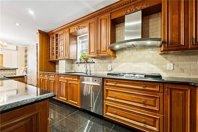 a kitchen with stainless steel appliances granite countertop sink stove and cabinets