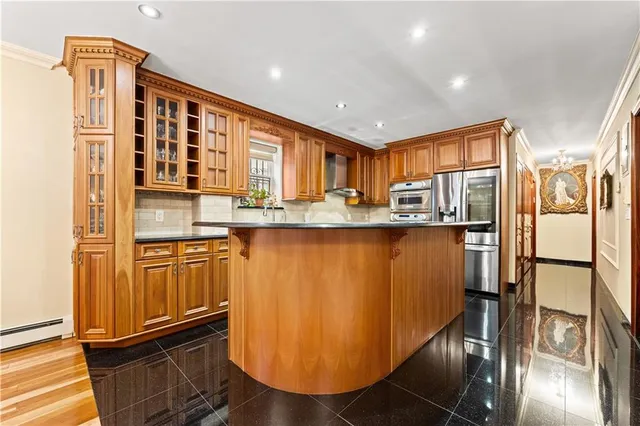 a kitchen with stainless steel appliances granite countertop a refrigerator and a stove top oven