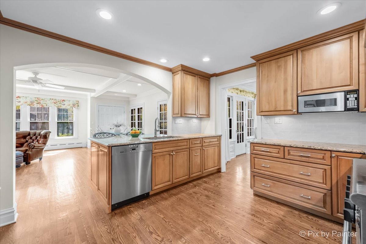 705 Hunter Road Glenview, IL 60025 - Photo 12 of 51 a large kitchen with stainless steel appliances granite countertop a stove and a refrigerator