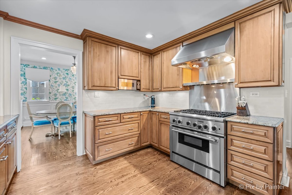 705 Hunter Road Glenview, IL 60025 - Photo 13 of 51 a kitchen with a stove a sink and a refrigerator