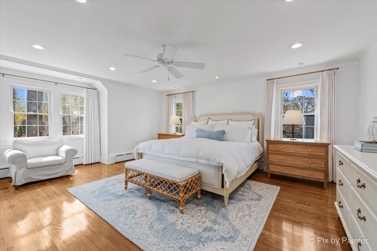 705 Hunter Road Glenview, IL 60025 - Photo 18 of 51 a spacious bedroom with a bed a couch and a window