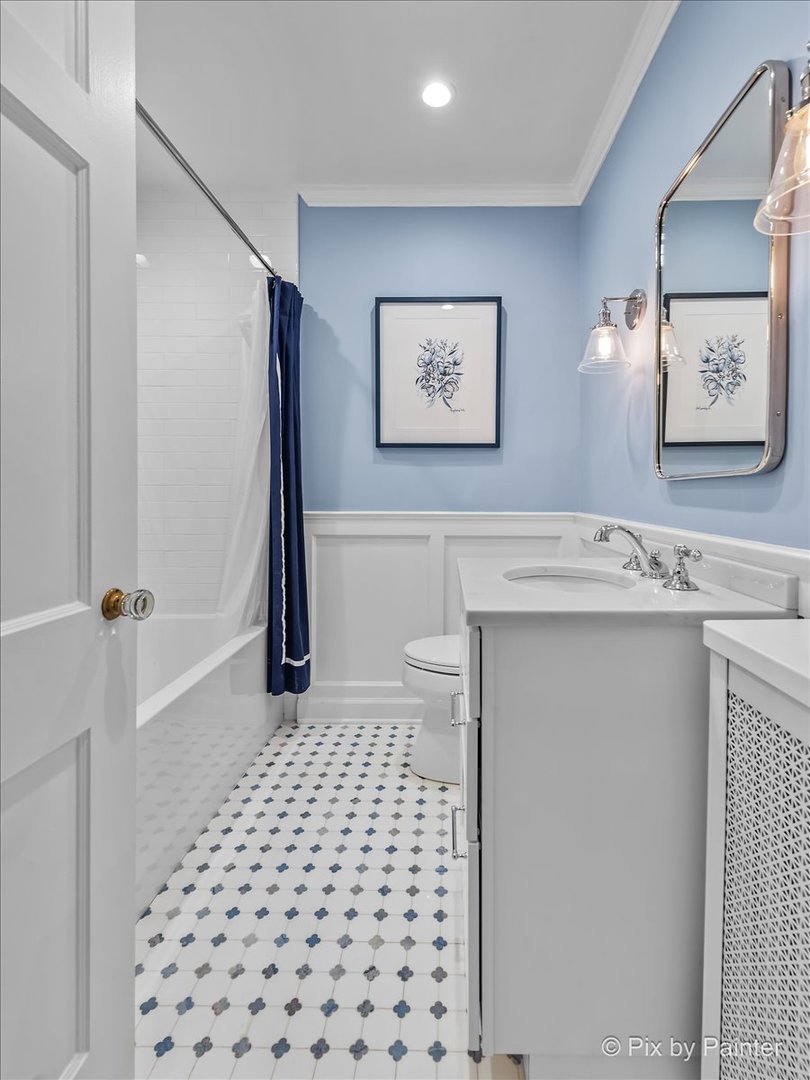 705 Hunter Road Glenview, IL 60025 - Photo 24 of 51 a bathroom with a sink a toilet a shower and a mirror