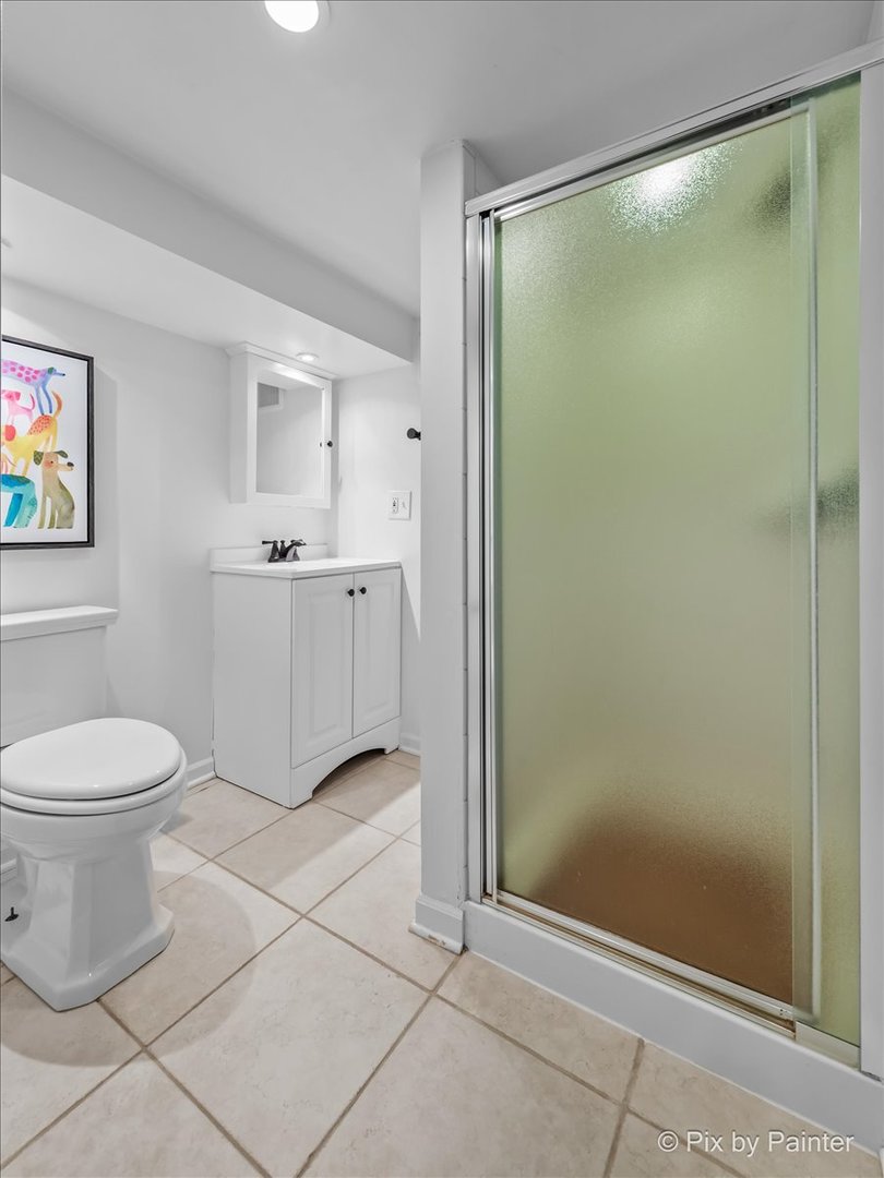 705 Hunter Road Glenview, IL 60025 - Photo 28 of 51 a bathroom with a granite countertop bathtub shower sink mirror and toilet