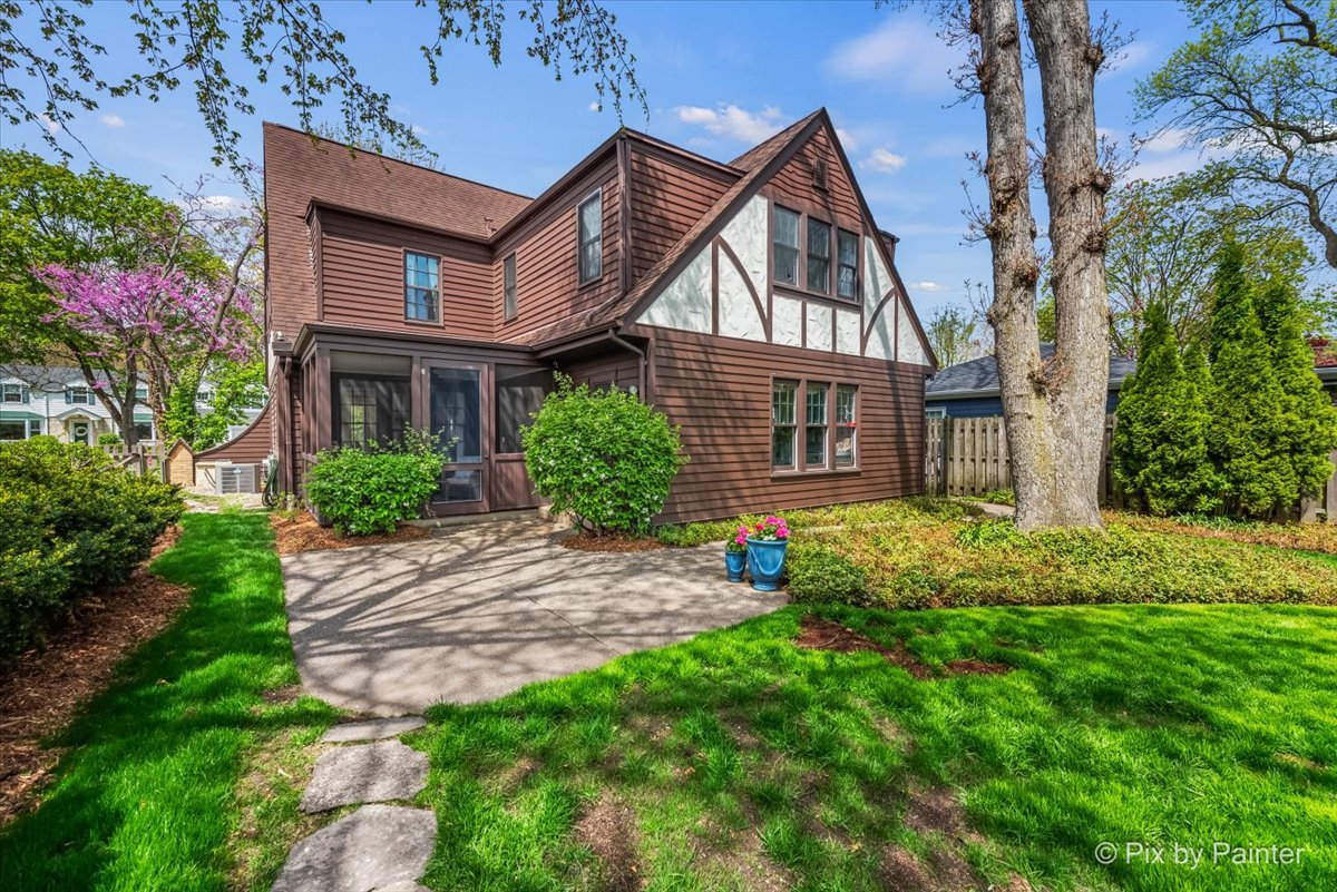 705 Hunter Road Glenview, IL 60025 - Photo 29 of 51 a view of a brick house with a yard plants and large tree