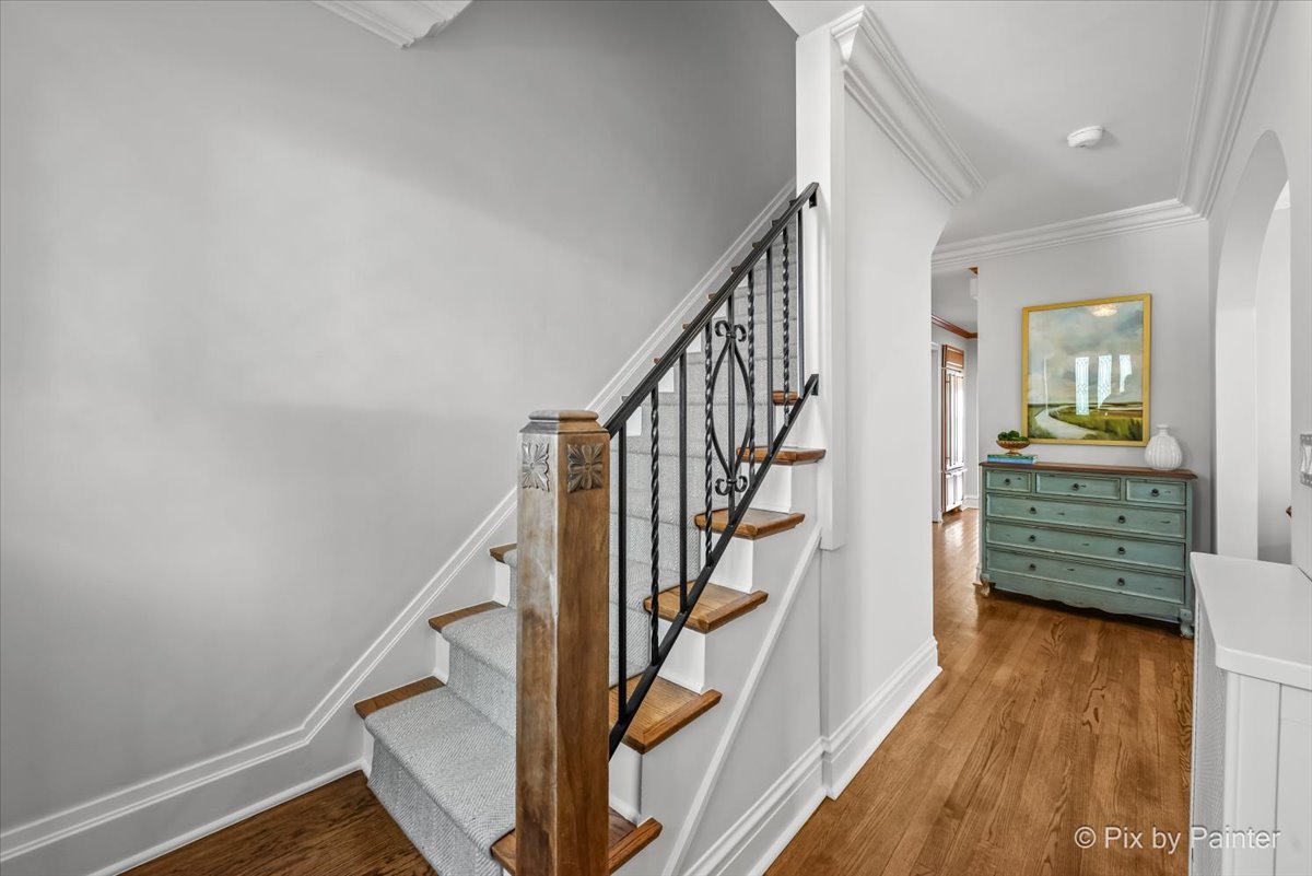 705 Hunter Road Glenview, IL 60025 - Photo 7 of 51 a view of entryway with wooden floor and stairs