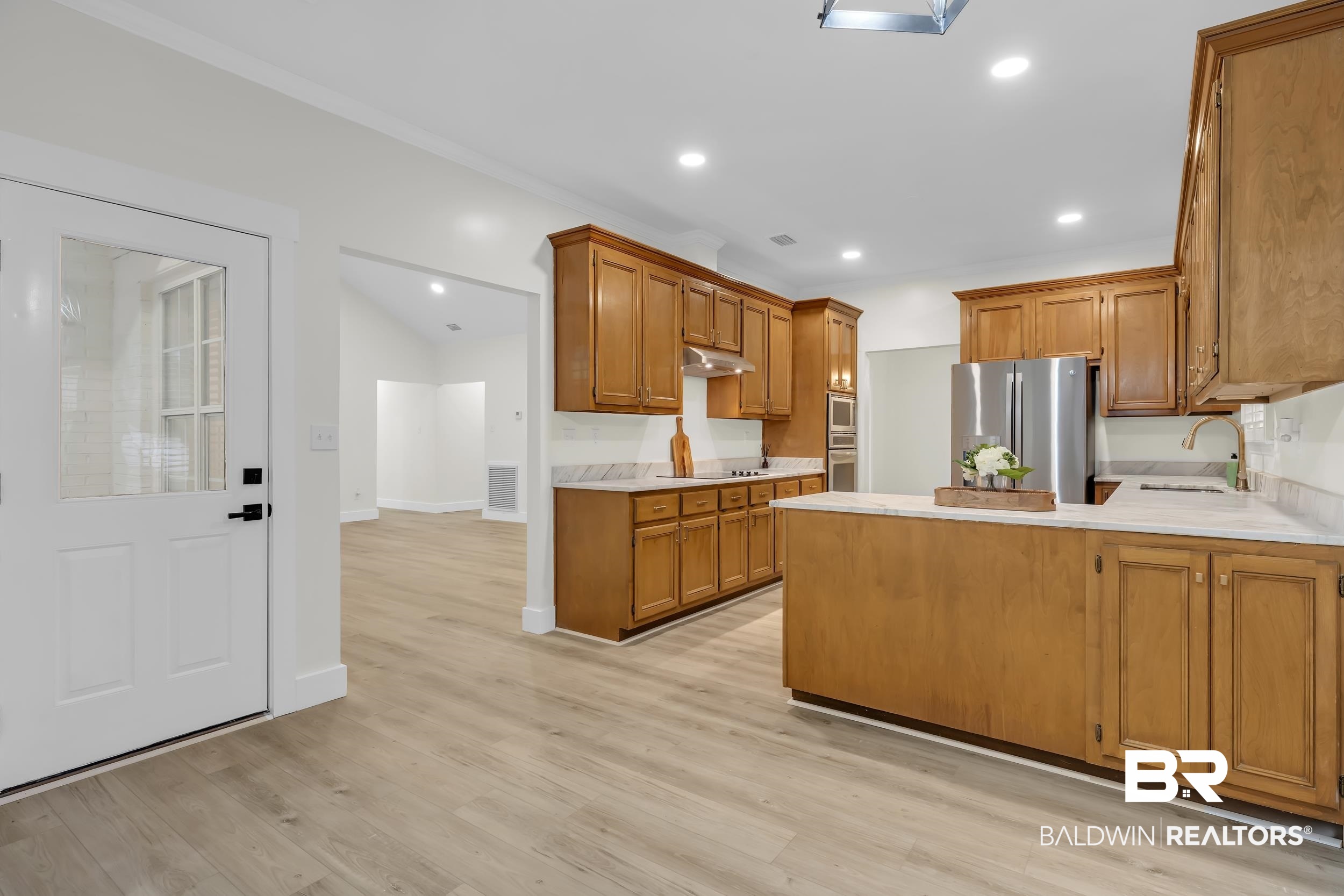 4924 Brooke Court Mobile, AL 36618 - Photo 17 of 34 Kitchen with a peninsula, brown cabinets, stainless steel appliances, light wood-type flooring, and recessed lighting