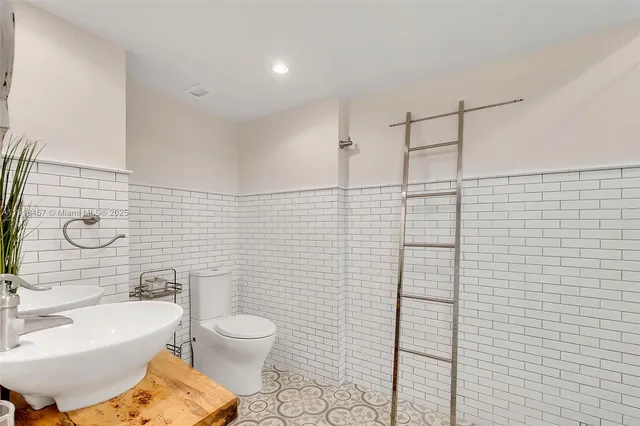 a bathroom with a toilet sink and shower