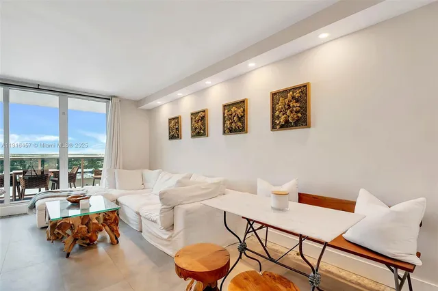 a living room with furniture and a floor to ceiling window