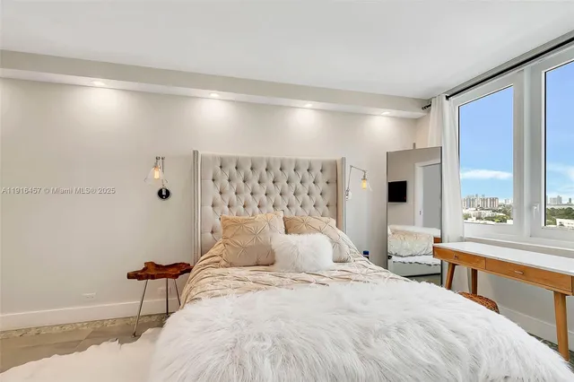 a bedroom with a large bed and a large window