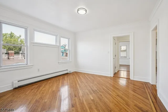 a kitchen with a sink wooden floor and stainless steel appliances