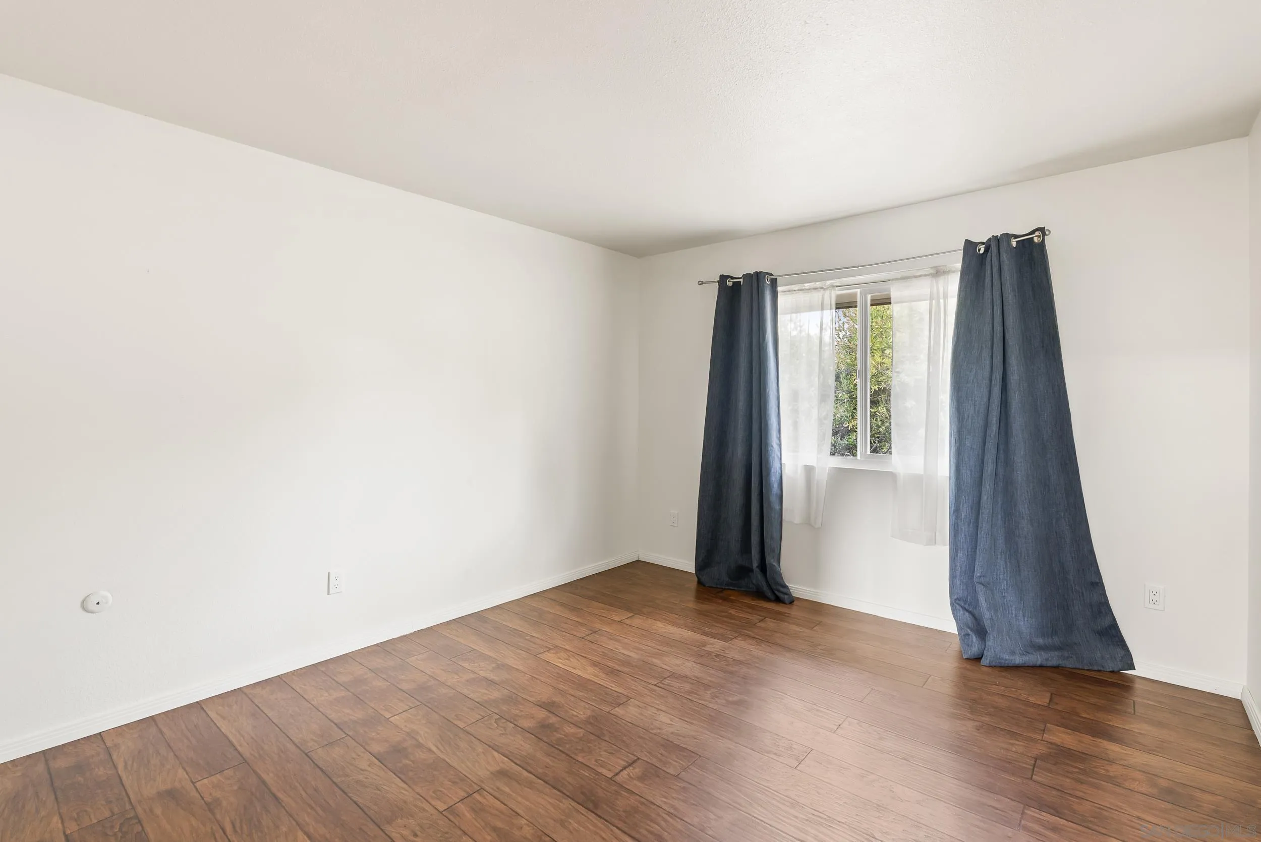 1429 Midway Drive Alpine, CA 91901 - Photo 31 of 42 an empty room with wooden floor and entrance