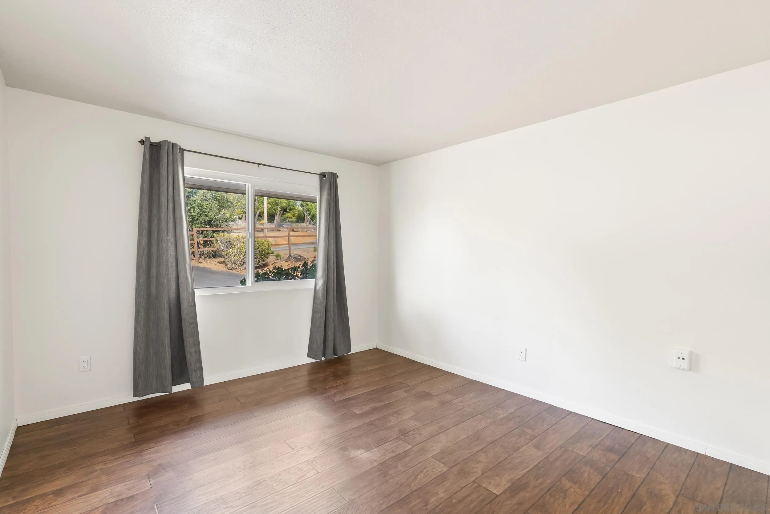 1429 Midway Drive Alpine, CA 91901 - Photo 32 of 42 a view of an empty room with wooden floor and a window