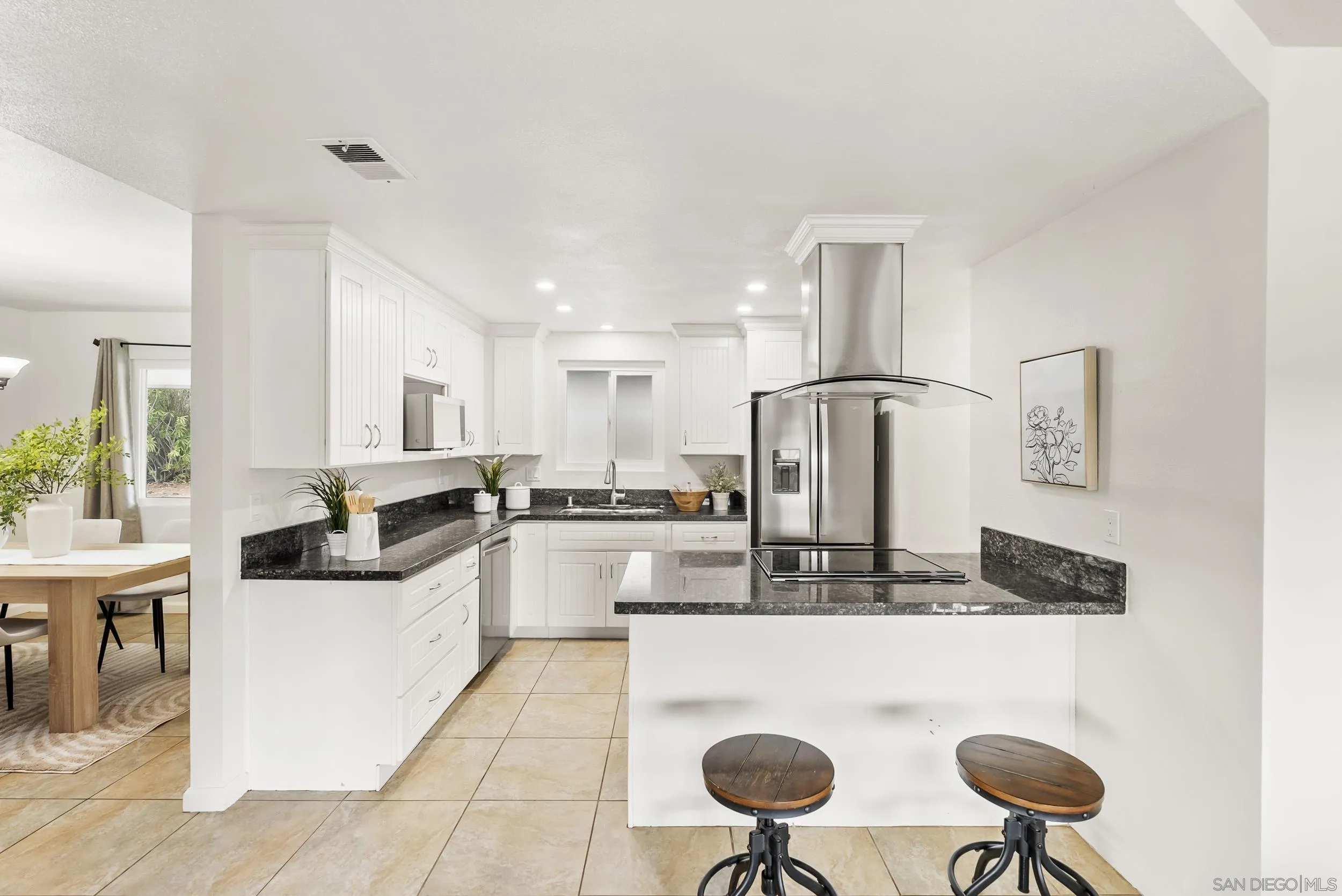 1429 Midway Drive Alpine, CA 91901 - Photo 6 of 42 a kitchen with stainless steel appliances granite countertop a refrigerator a stove and white cabinets