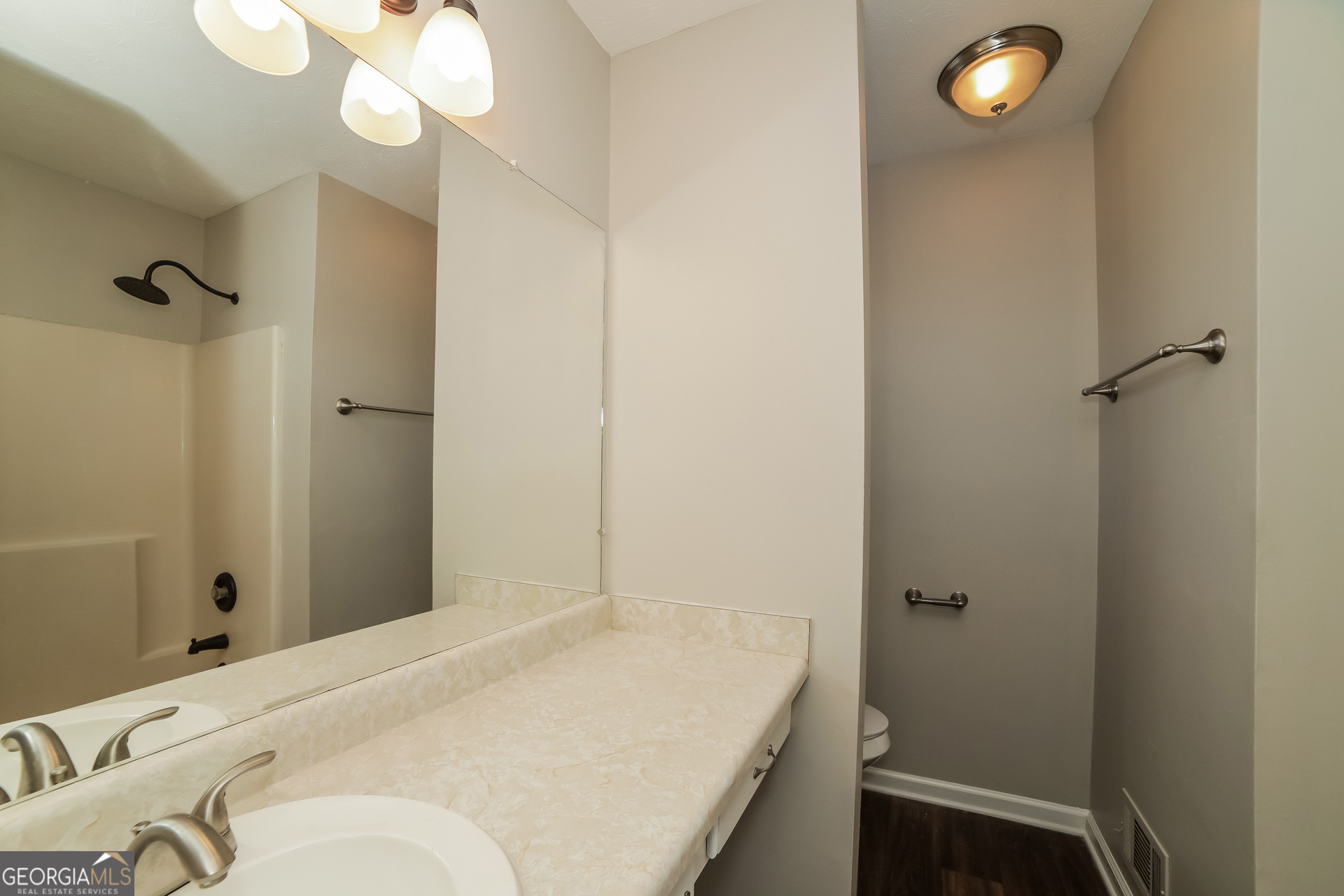 499 Woodland Street Dallas, GA 30157 - Photo 11 of 17 a bedroom with a bed and a chandelier