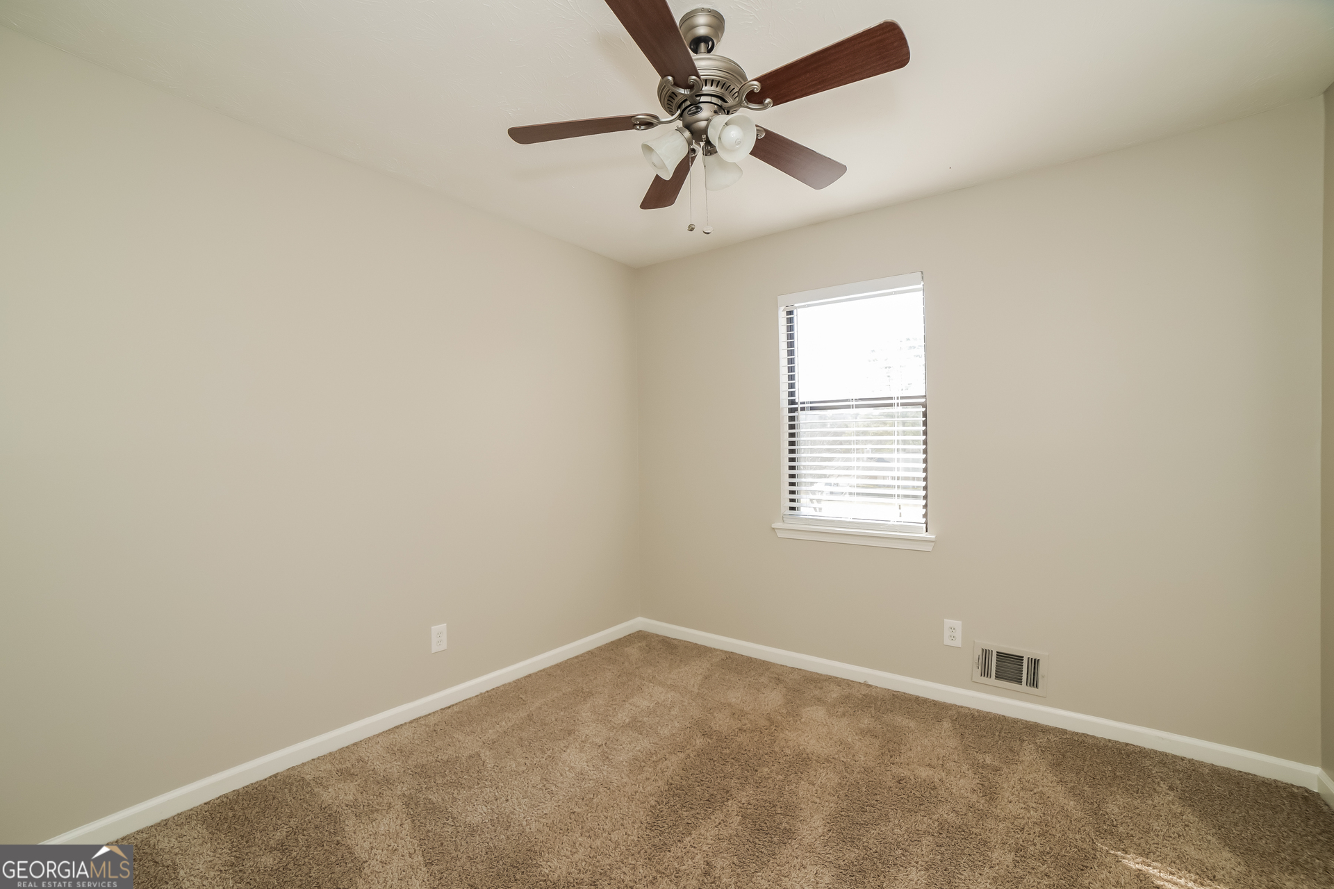 499 Woodland Street Dallas, GA 30157 - Photo 13 of 17 an empty room with a window and a fan