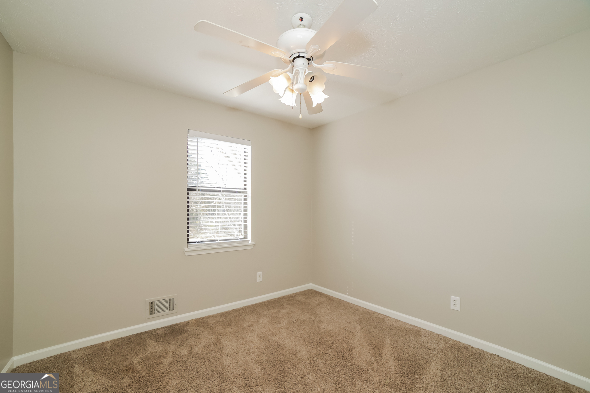 499 Woodland Street Dallas, GA 30157 - Photo 14 of 17 an empty room with windows and fan