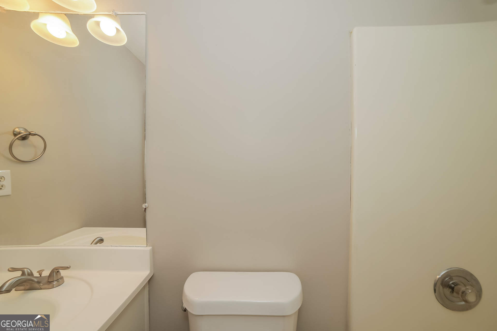 499 Woodland Street Dallas, GA 30157 - Photo 16 of 17 a bathroom with a toilet a sink and mirror