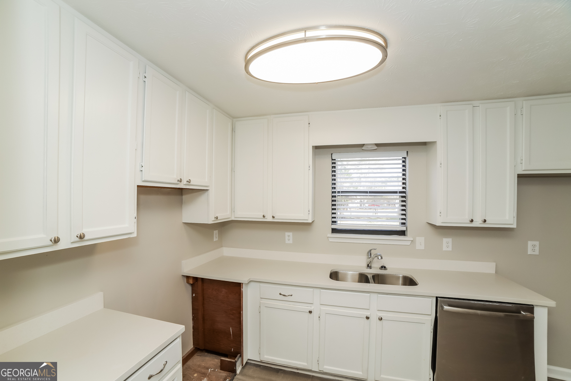 499 Woodland Street Dallas, GA 30157 - Photo 8 of 17 a kitchen with a sink cabinets and window
