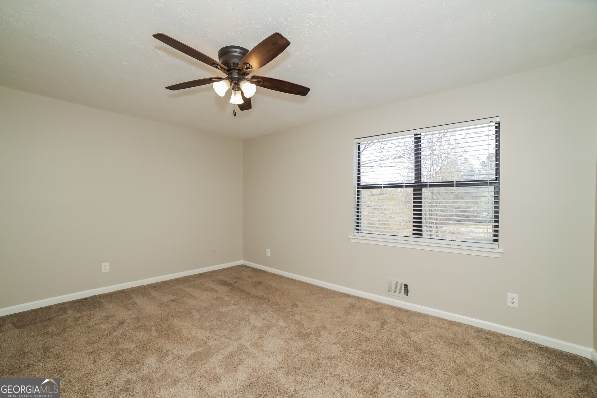 499 Woodland Street Dallas, GA 30157 - Photo 10 of 17 an empty room with a window and a fan