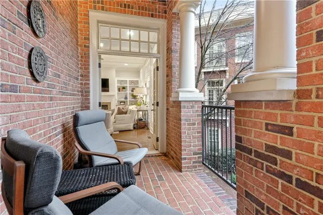 a kitchen with stainless steel appliances granite countertop wooden cabinets a dining table and chairs