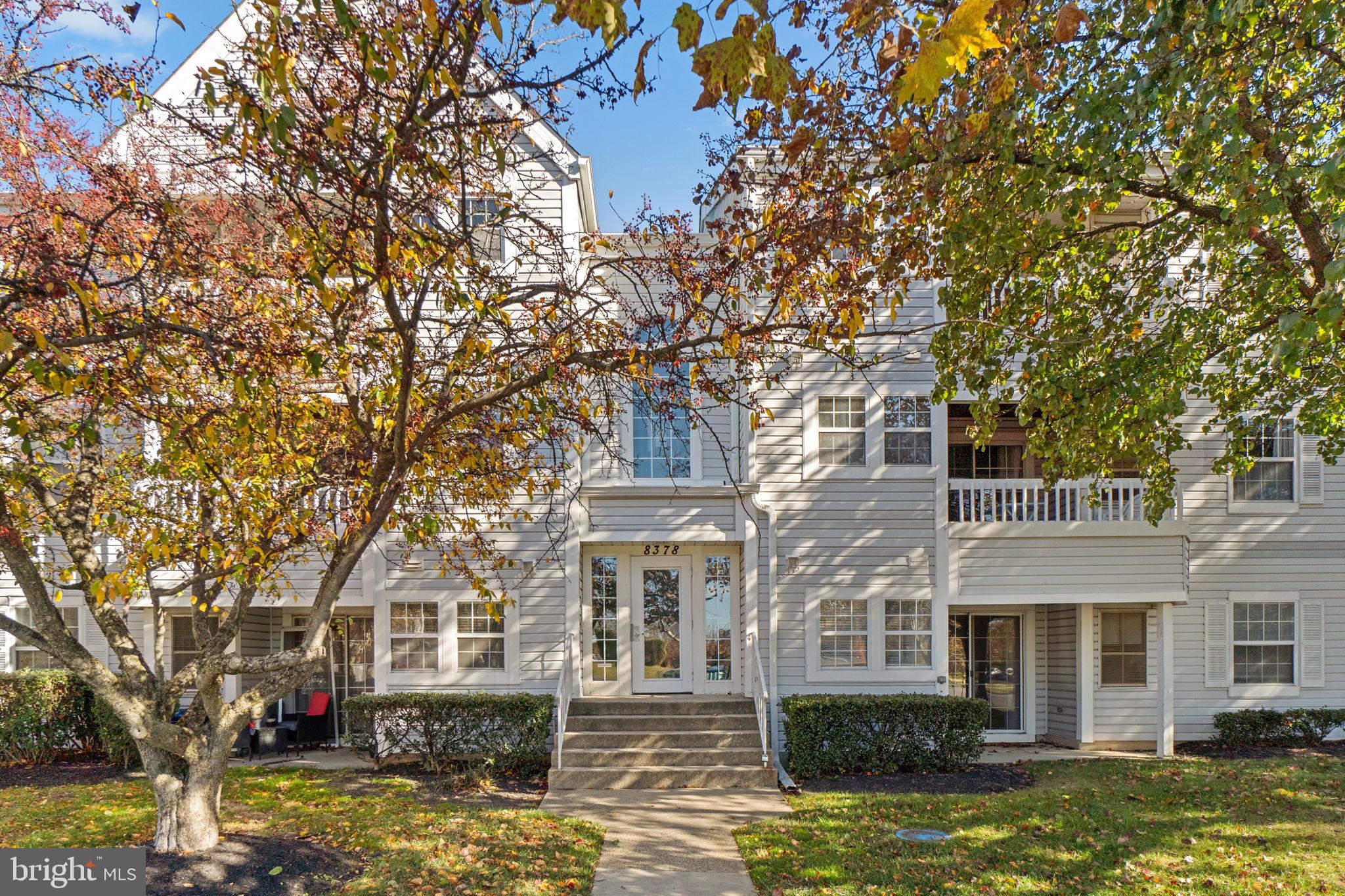 8378 Montgomery Run Road, Unit D Ellicott City, MD 21043 - Photo 1 of 30 a front view of a house with a garden