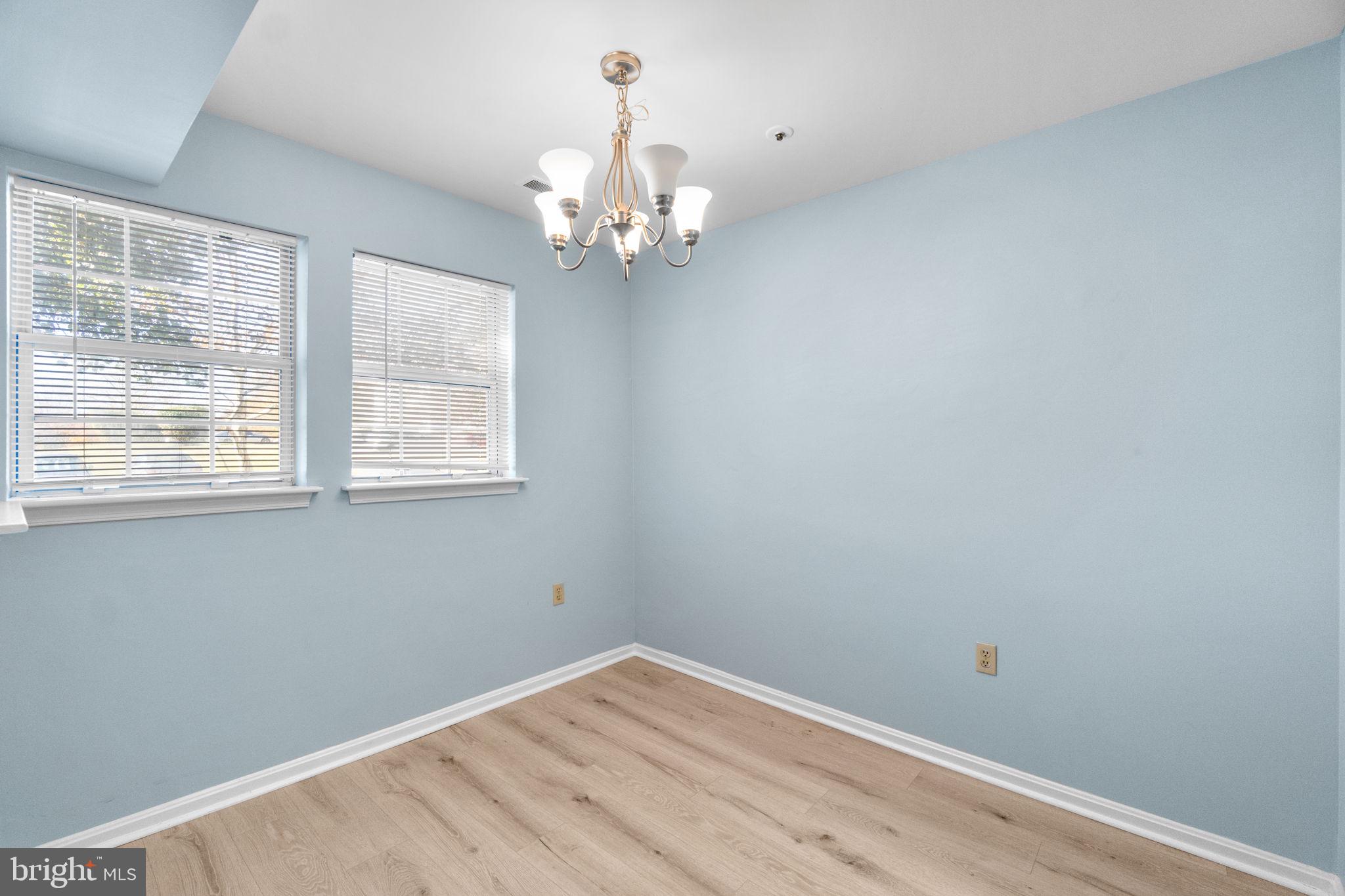 8378 Montgomery Run Road, Unit D Ellicott City, MD 21043 - Photo 11 of 30 a view of a room with wooden floor and windows