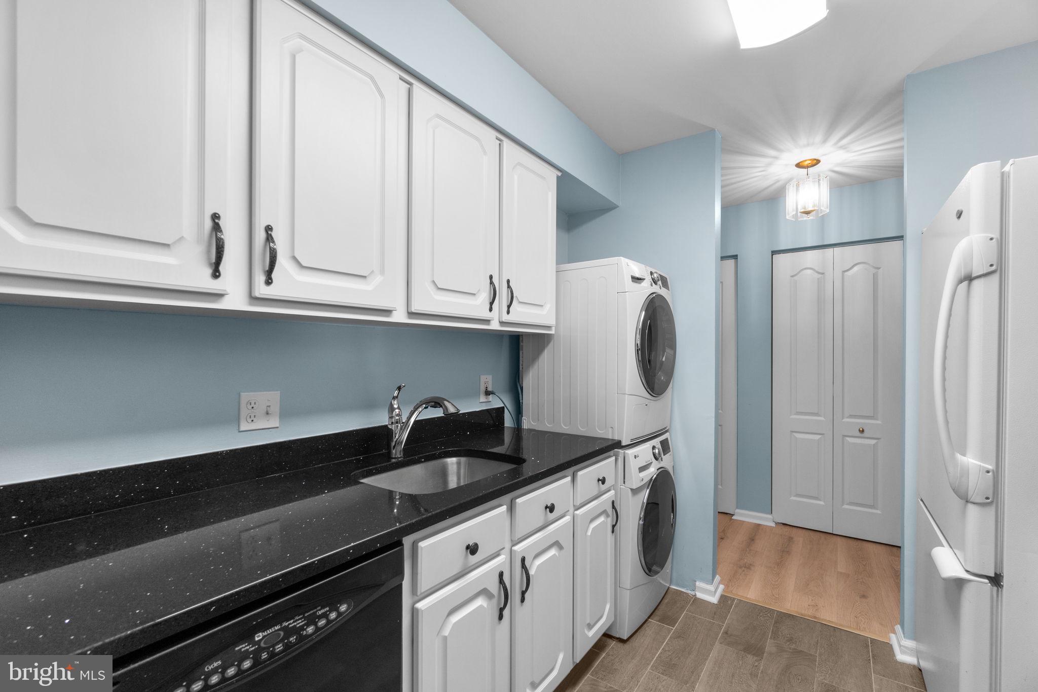 8378 Montgomery Run Road, Unit D Ellicott City, MD 21043 - Photo 15 of 30 a kitchen with stainless steel appliances granite countertop a sink and a refrigerator