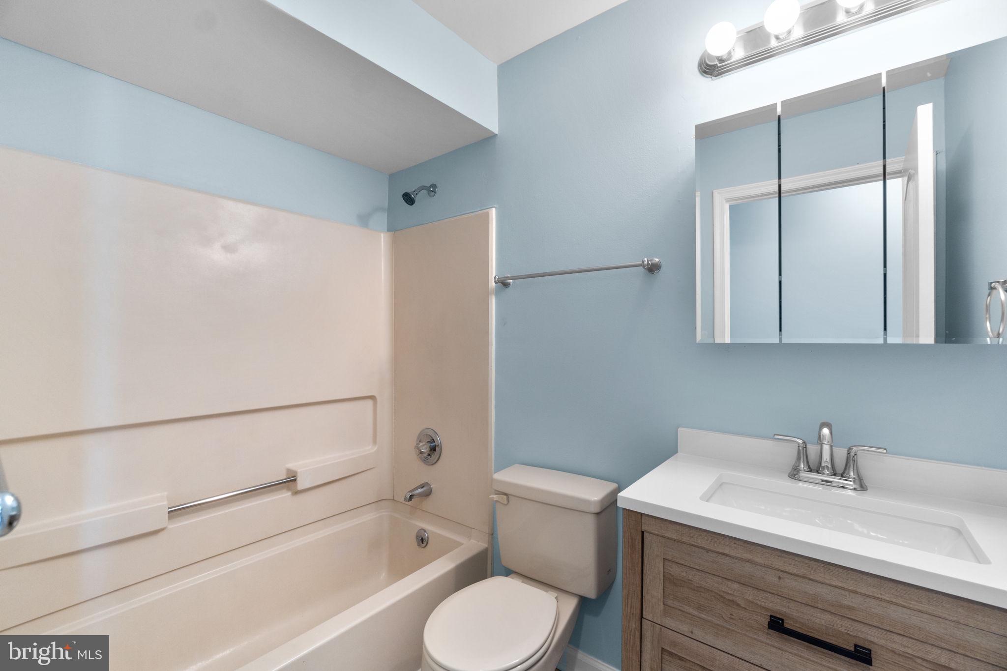 8378 Montgomery Run Road, Unit D Ellicott City, MD 21043 - Photo 18 of 30 a bathroom with a sink toilet and shower