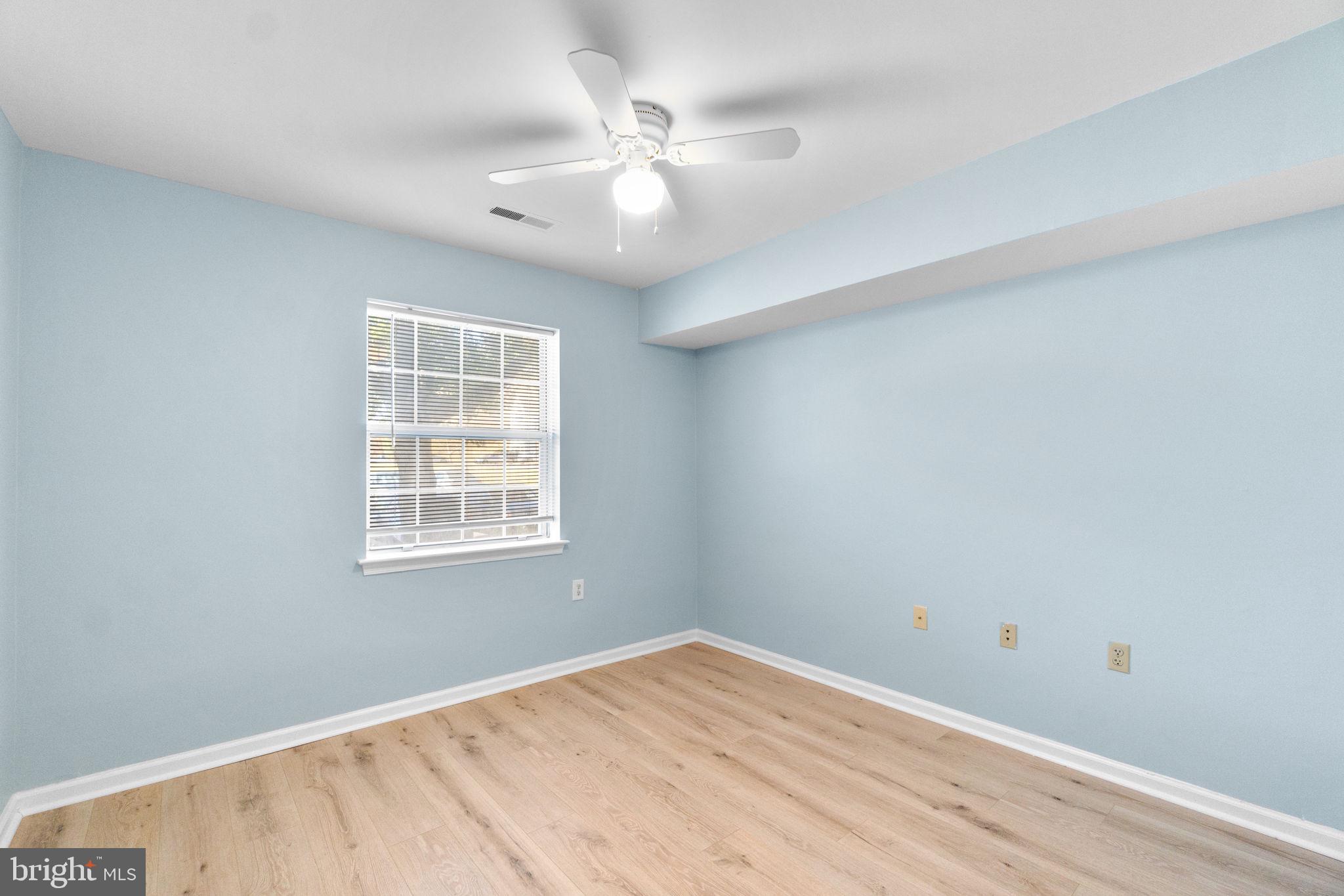 8378 Montgomery Run Road, Unit D Ellicott City, MD 21043 - Photo 19 of 30 wooden floor in an empty room with a window