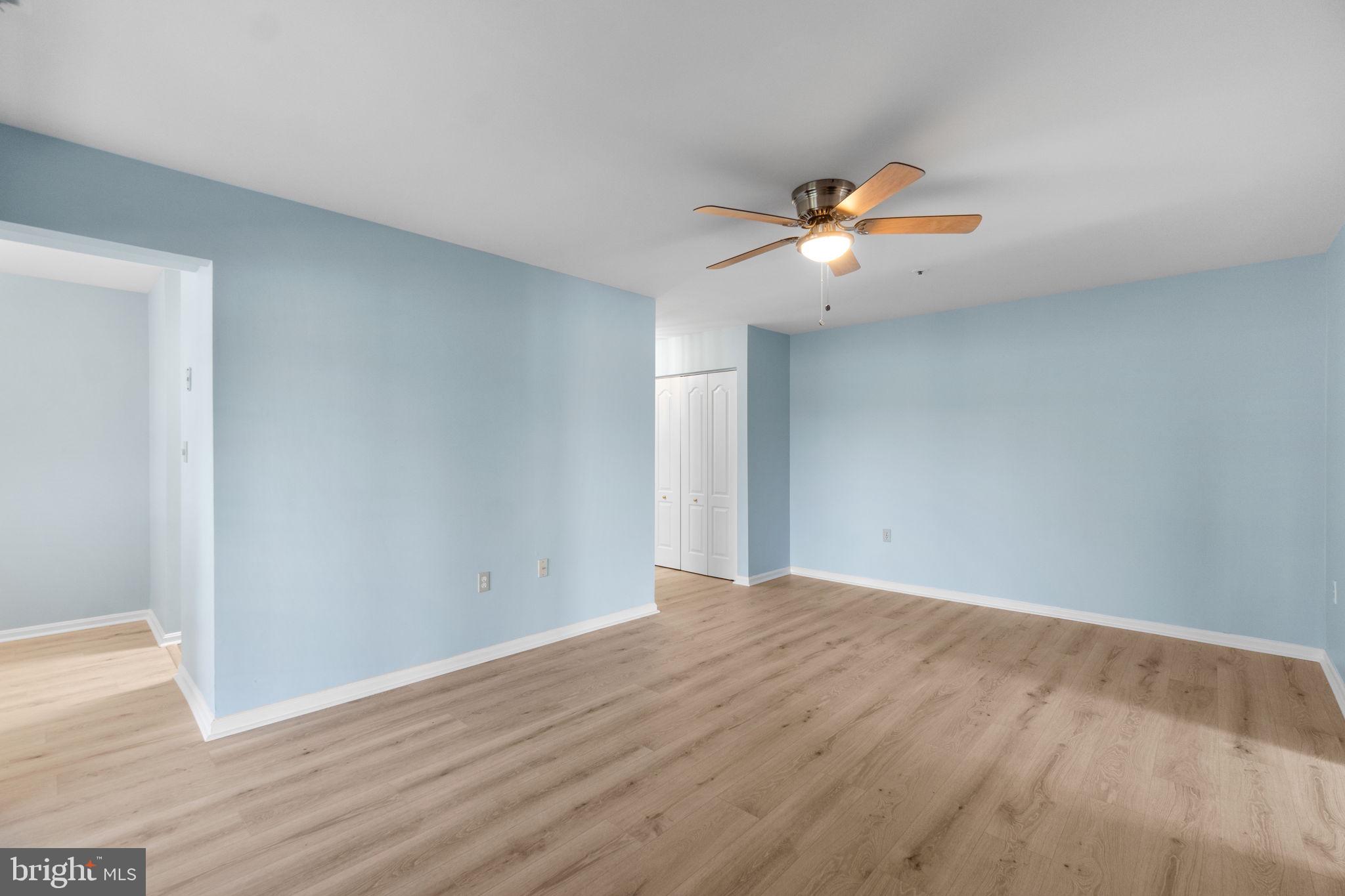 8378 Montgomery Run Road, Unit D Ellicott City, MD 21043 - Photo 9 of 30 a view of a big room with wooden floor and a ceiling fan