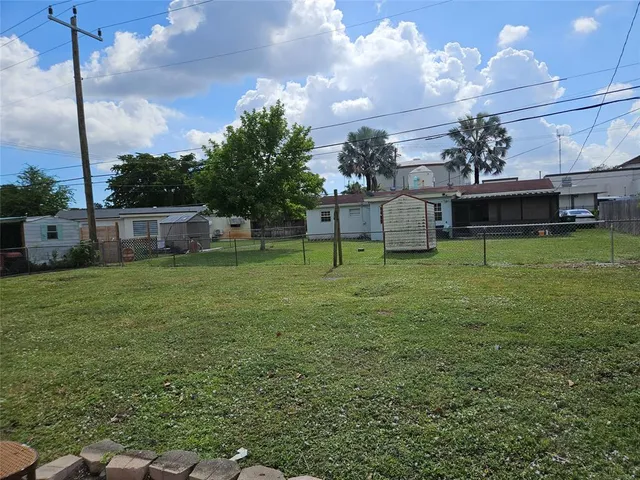 a view of a house with a yard and sitting area
