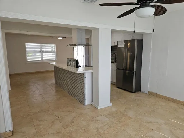 a view of a kitchen with a refrigerator cabinets and a window