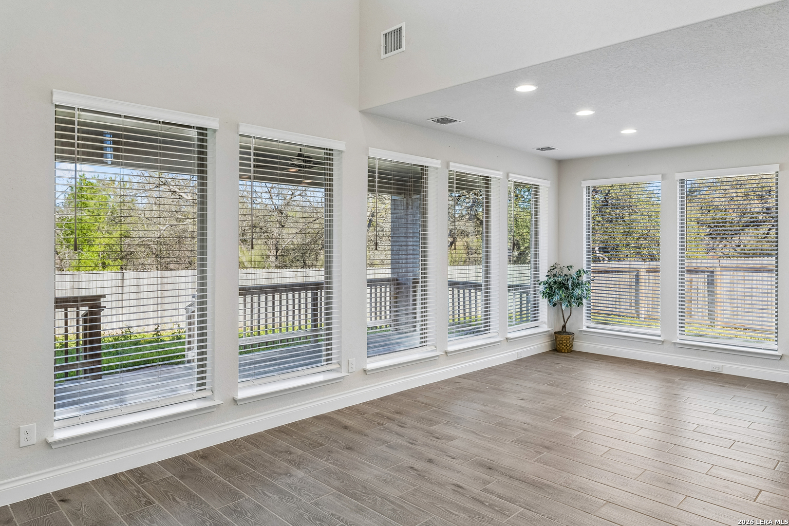 63 Ricadonna San Antonio, TX 78253 - Photo 12 of 43 a view of empty room with wooden floor and floor to ceiling window