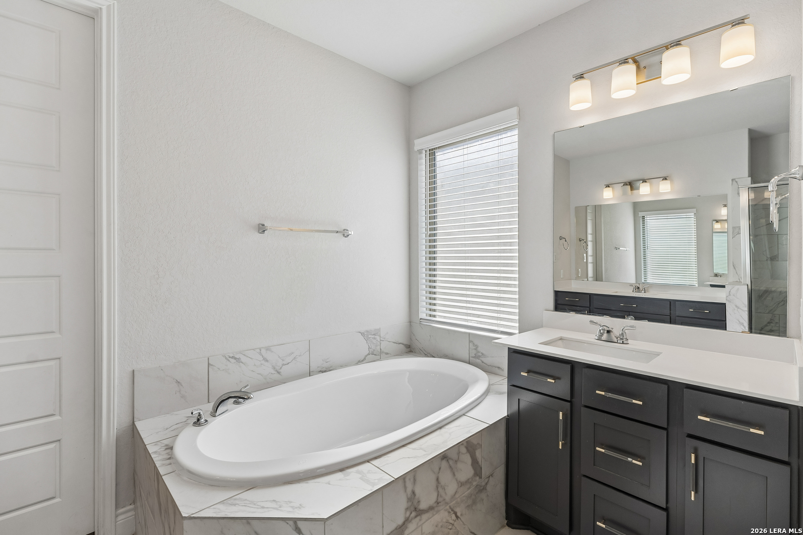 63 Ricadonna San Antonio, TX 78253 - Photo 18 of 43 a bathroom with a tub sink and mirror