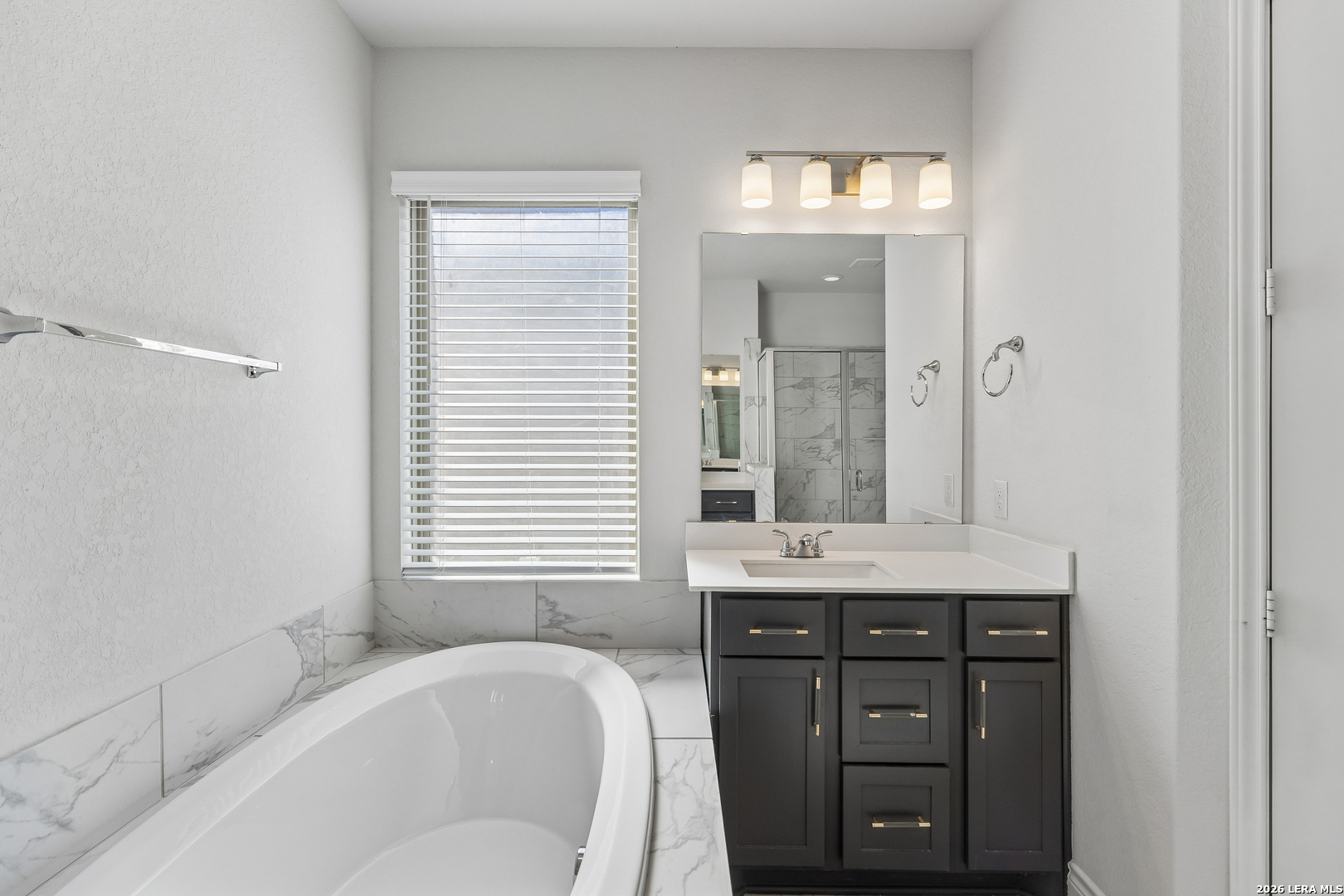 63 Ricadonna San Antonio, TX 78253 - Photo 19 of 43 a bathroom with a granite countertop sink a mirror and a bathtub