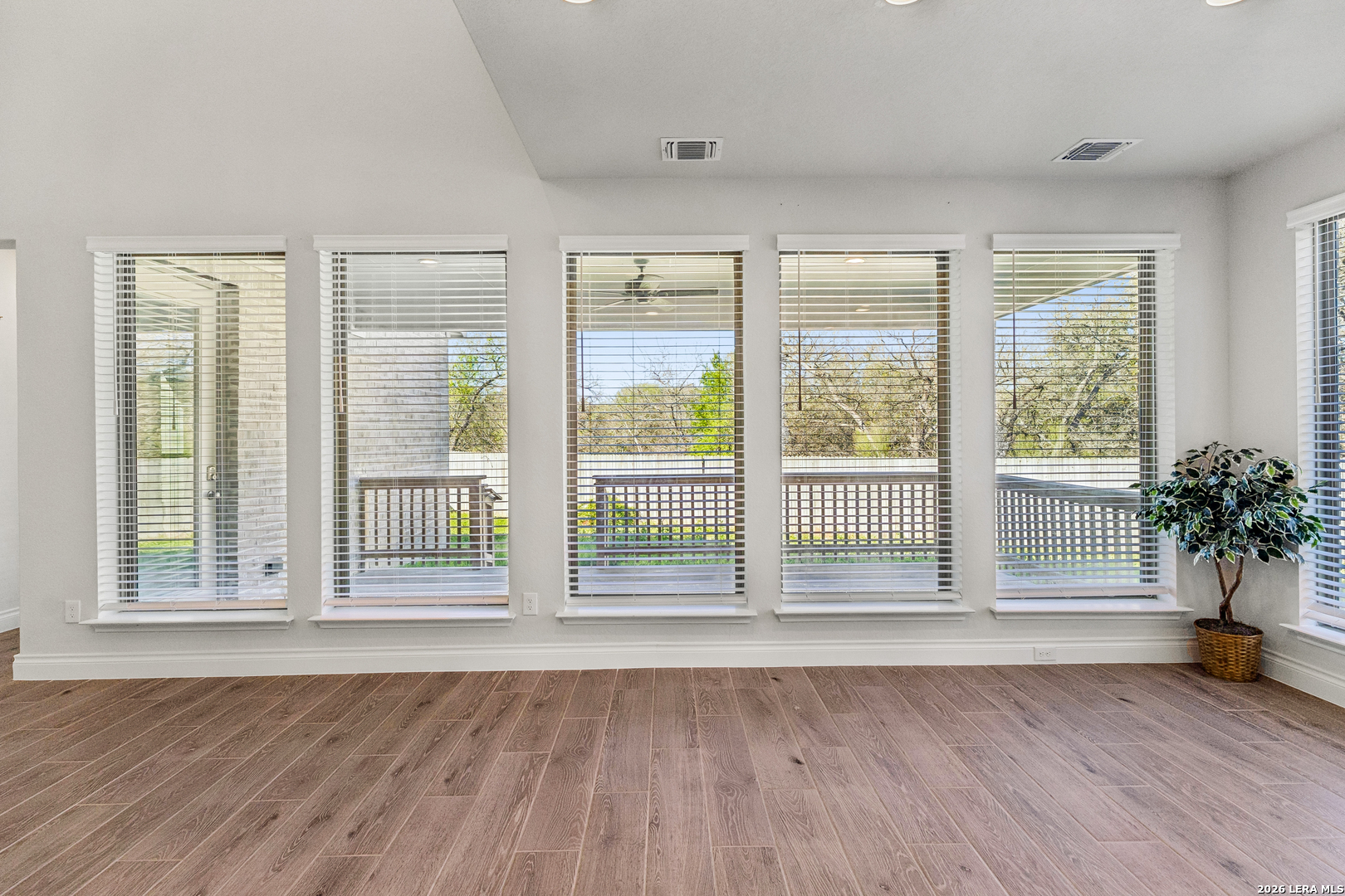 63 Ricadonna San Antonio, TX 78253 - Photo 21 of 43 a view of empty room with wooden floor and floor to ceiling window