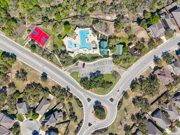 a view of a swimming pool with a patio and a yard