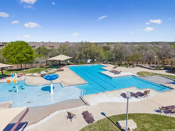 a view of a house with swimming pool and sitting area