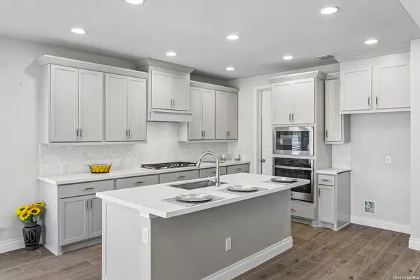 a kitchen with stainless steel appliances a sink stove and refrigerator
